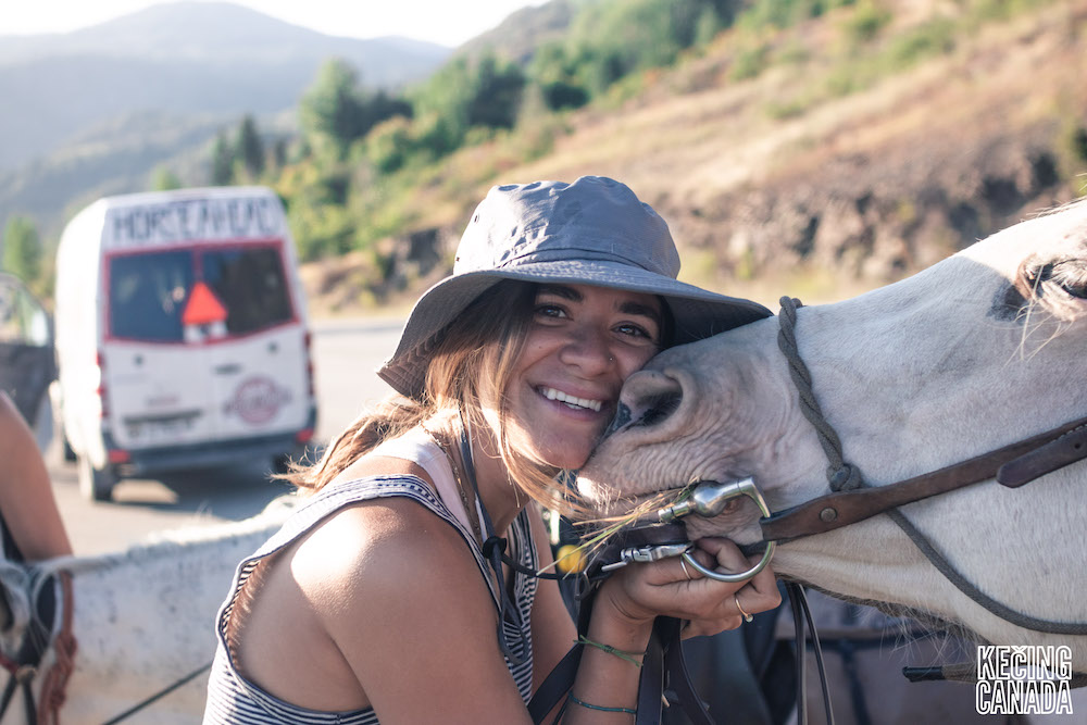 girl snuggling horse - Across Canada by horse