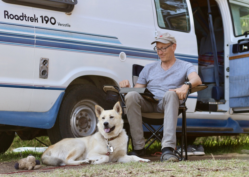 dog and owner in front of van - finding dog-friendly campsites