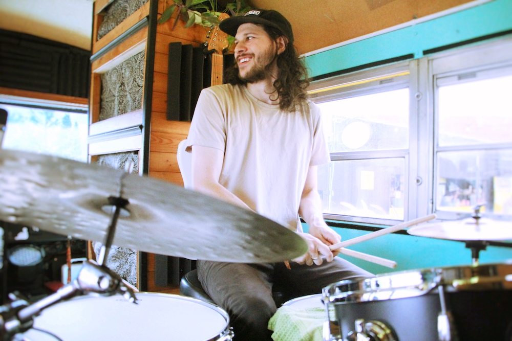 man playing drums in the mixbus studio