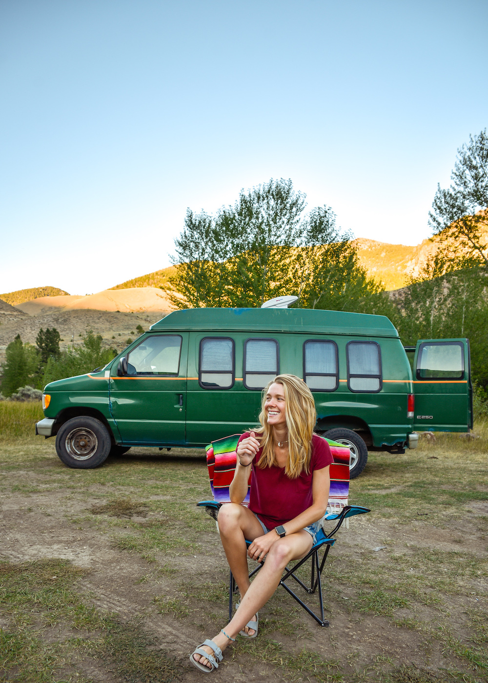 girl sitting in front of van - living full-time van life