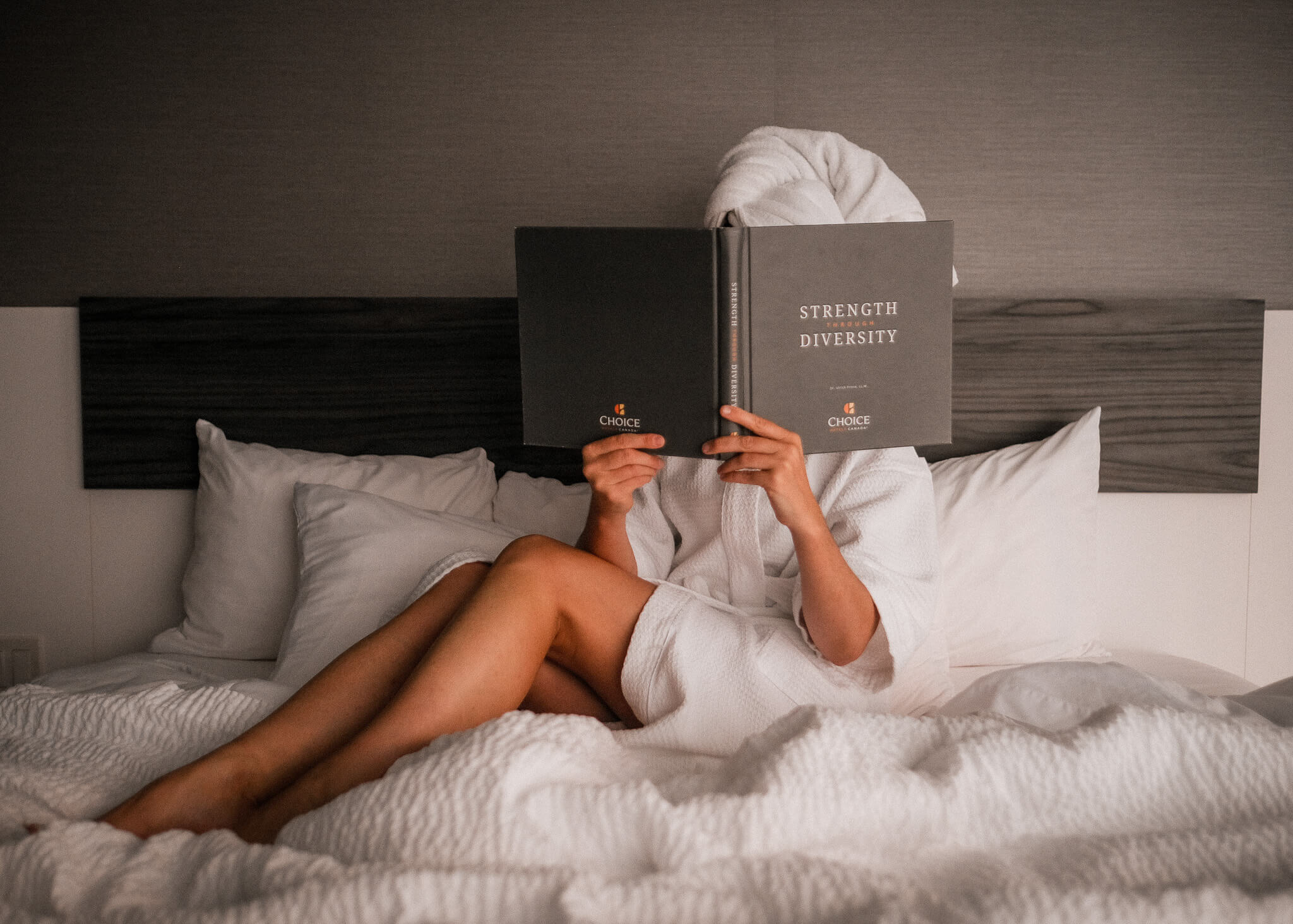 Woman in a Choice Hotel bed